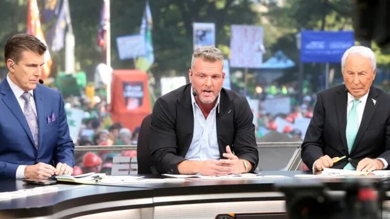 Host Pat McAfee, center, makes a point while Rece Davis, left, and Lee Corso look on during...