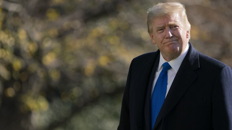 President Donald Trump walks on the South Lawn of the White House in Washington, Sunday, Nov....