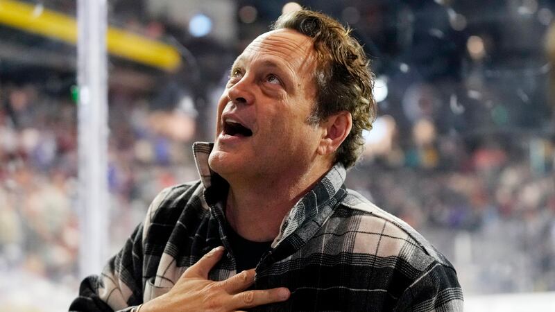 Actor Vince Vaughn talks to fans between periods of an NHL hockey game between the Arizona...