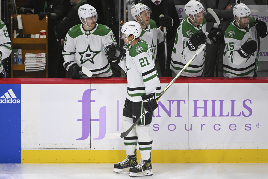 Dallas Stars left wing Jason Robertson celebrates with he bench after scoring a goal against...