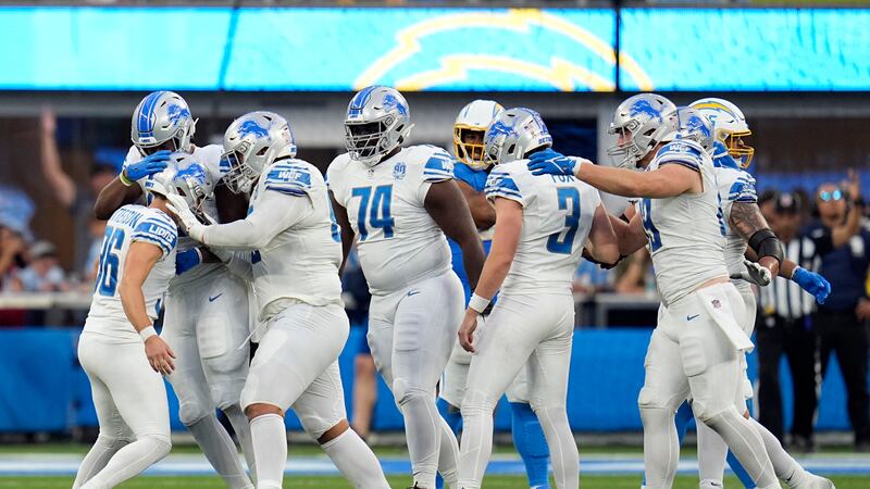 Detroit Lions place kicker Riley Patterson, left, celebrates with teammates after making the...