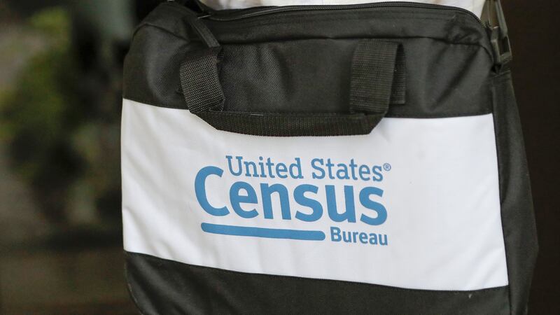 A briefcase of a census taker is seen as she knocks on the door of a residence Aug. 11, 2020,...