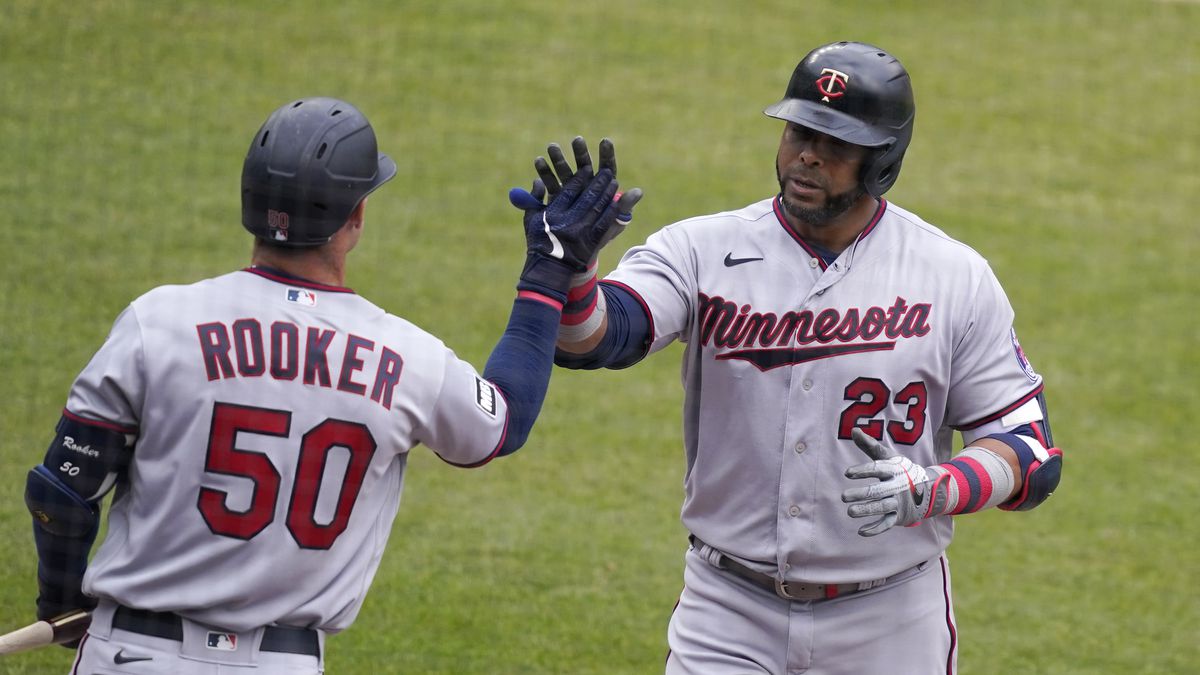 Minnesota Twins designated hitter Nelson Cruz (23) is greeted by teammate Max Kepler after...